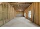 Unfinished basement featuring stud framing, concrete floor, windows and access to other rooms at 741 Cams Crk, Mcdonough, GA 30253