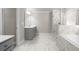 Bathroom featuring double sink vanity, a glass shower, a tub, and marble-style tile at 741 Cams Crk, Mcdonough, GA 30253