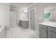 Bathroom featuring double sink vanity and marble-style tile at 741 Cams Crk, Mcdonough, GA 30253