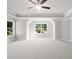 Spacious bedroom featuring a tray ceiling, carpet, windows, and white trim at 741 Cams Crk, Mcdonough, GA 30253