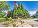 Welcoming community entrance with American flag, manicured landscaping, and clear signage for The Estates at Cameron Manor at 741 Cams Crk, Mcdonough, GA 30253