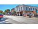 Charming downtown street with storefronts, outdoor dining, and visible 'Now Open' signage for local businesses at 741 Cams Crk, Mcdonough, GA 30253