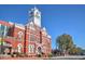 Beautiful brick building featuring a clock tower, multiple stories, arched doorways, and manicured landscaping at 741 Cams Crk, Mcdonough, GA 30253