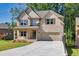 Charming two-story home features a brick facade, a spacious driveway, and a well-manicured lawn at 741 Cams Crk, Mcdonough, GA 30253