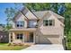 Charming two-story home features a brick facade, covered porch, and attached two-car garage at 741 Cams Crk, Mcdonough, GA 30253