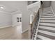 Spacious foyer with hardwood floors, staircase with iron balusters, and archway leading to living area at 741 Cams Crk, Mcdonough, GA 30253