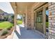 Inviting front porch with brick columns and trim detail surrounding a decorative glass front door at 741 Cams Crk, Mcdonough, GA 30253