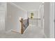 Upstairs hallway features carpet, iron railing and lots of natural light at 741 Cams Crk, Mcdonough, GA 30253