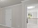 Hallway featuring a door, access to the second floor, and gray walls at 741 Cams Crk, Mcdonough, GA 30253