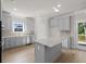 Kitchen features gray cabinets, granite countertops, stainless appliances, and a center island at 741 Cams Crk, Mcdonough, GA 30253