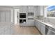 Kitchen features gray cabinets, granite countertops, stainless appliances, and hardwood floors at 741 Cams Crk, Mcdonough, GA 30253