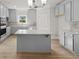 Modern kitchen features gray cabinets, granite countertops, and a center island at 741 Cams Crk, Mcdonough, GA 30253
