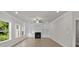 Bright living room featuring a fireplace, built-in shelving, ceiling fan, and hardwood floors at 741 Cams Crk, Mcdonough, GA 30253