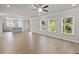 Open concept living room and kitchen featuring hardwood floors, gray cabinets, and granite countertops at 741 Cams Crk, Mcdonough, GA 30253