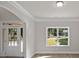 Bright living room with large windows, hardwood floors, and elegant trim at 741 Cams Crk, Mcdonough, GA 30253