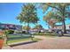 Charming town square with benches, manicured lawns, and views of local businesses under a clear blue sky at 741 Cams Crk, Mcdonough, GA 30253