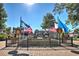 Scenic town square featuring a fountain, multiple flags, and a view of local shops on a bright day at 741 Cams Crk, Mcdonough, GA 30253