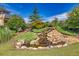 Landscaped grounds featuring water feature with rock outcroppings and ponding water at 741 Cams Crk, Mcdonough, GA 30253