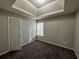 Well-lit bedroom featuring a tray ceiling and closet at 916 Brisley Cir, Hampton, GA 30228