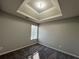 Spacious bedroom with tray ceiling and large window at 916 Brisley Cir, Hampton, GA 30228