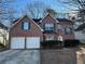Brick house with two-car garage and manicured landscaping at 916 Brisley Cir, Hampton, GA 30228