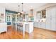 Modern kitchen with white cabinets, large island, and hardwood floors at 2188 Niles Pl, Atlanta, GA 30324
