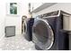 Laundry room with modern washer and dryer and geometric floor tile at 2188 Niles Pl, Atlanta, GA 30324