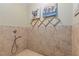 Dog shower with hand sprayer, and accent tile with dog art above at 4755 Riverview Rd, Atlanta, GA 30327