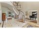 Grand foyer featuring a curved staircase, elegant marble floors, and an open layout to the living spaces at 4755 Riverview Rd, Atlanta, GA 30327