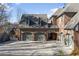 Three-car brick garage with paver driveway and a separate deck at 4755 Riverview Rd, Atlanta, GA 30327