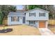 Newly renovated light grey house with brown garage door and manicured lawn at 5088 Rockborough Trl, Norcross, GA 30071