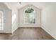 Bright living room featuring hardwood floors and a large arched window at 80 Keyton Dr, Covington, GA 30016