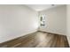 Minimalist bedroom featuring wood floors, neutral walls, and a window with a view at 3605 Brycewood Dr, Decatur, GA 30034