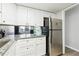 Galley kitchen with white cabinets and granite counters at 524 Granite Ridge Pl, Atlanta, GA 30350