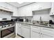 Galley kitchen with white cabinets and granite counters at 524 Granite Ridge Pl, Atlanta, GA 30350