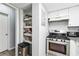 Galley kitchen with white cabinets and granite counters at 524 Granite Ridge Pl, Atlanta, GA 30350
