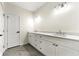 Bright bathroom features a double vanity with white cabinets and modern fixtures, complemented by stylish tile flooring at 3607 Brycewood Dr, Decatur, GA 30034