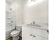 A well-lit bathroom featuring a white vanity, toilet, and shower with tub at 3607 Brycewood Dr, Decatur, GA 30034