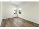 A bright bedroom with hardwood flooring and windows, showing an exterior view of trees at 3607 Brycewood Dr, Decatur, GA 30034