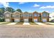 New townhomes feature brick and neutral siding, garages, and well-maintained lawns at 3607 Brycewood Dr, Decatur, GA 30034