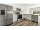 Modern kitchen boasts stainless steel appliances, white cabinetry, and an open layout at 3607 Brycewood Dr, Decatur, GA 30034