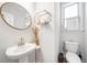 Elegant powder room with pedestal sink and gold accents at 1805 Wellston Dr, Lawrenceville, GA 30043