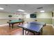 Well-lit game room with a pool table, ping pong table, and a mounted flat screen television at 300 Johnson Ferry Ne Rd # A706, Atlanta, GA 30328