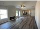 Open concept living room with kitchen view, fireplace and hardwood floors at 142 Tye St, Stockbridge, GA 30281