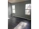 Well-lit bedroom with two large windows and gray walls at 6622 Wellington Sq, Norcross, GA 30093