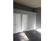 Well-lit bedroom with double door closet and gray walls at 6622 Wellington Sq, Norcross, GA 30093