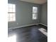 Bright bedroom with two large windows and gray walls at 6622 Wellington Sq, Norcross, GA 30093