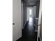 Long hallway with gray walls and dark flooring at 6622 Wellington Sq, Norcross, GA 30093