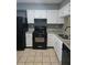 Updated kitchen with granite countertops and black appliances at 6622 Wellington Sq, Norcross, GA 30093
