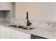 Granite countertop kitchen with double sink and modern faucet at 6622 Wellington Sq, Norcross, GA 30093
